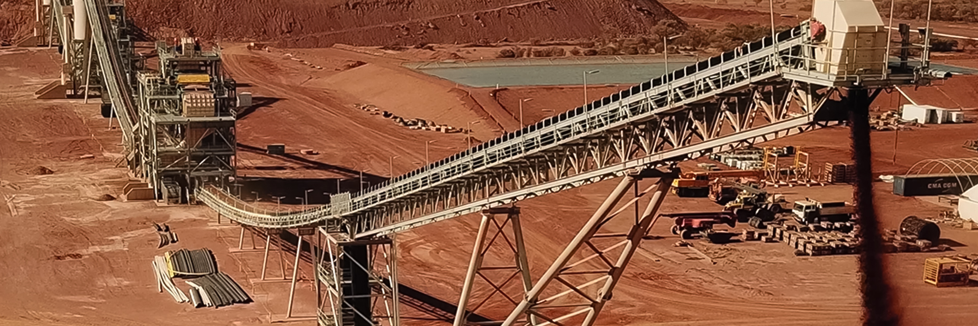 Rock processing operations in a quarry with red sand (photo)